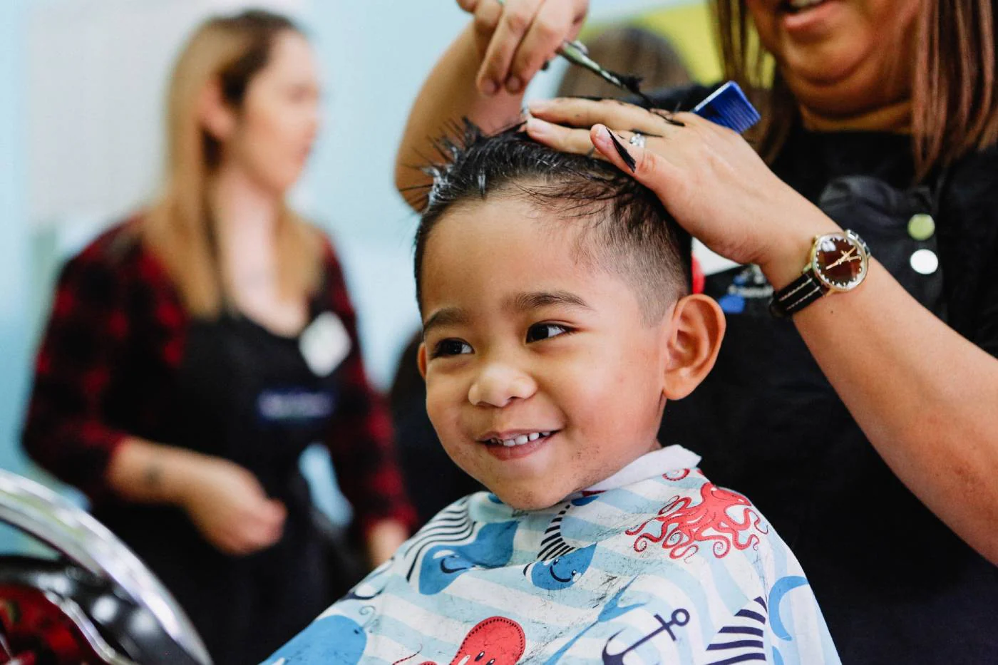Child receiving a fresh haircut from a professional stylist